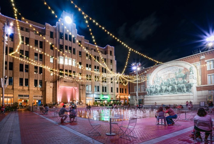 Fort Worth Sundance Square plaza at night with string lights and fountains