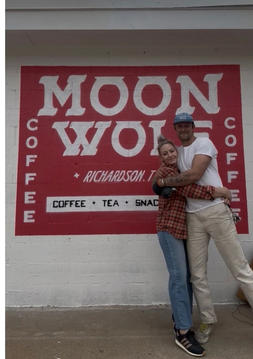 Sarah Ratliff and Stu Conry in front of the Moon Wolf cowgirl-on-wolf mural