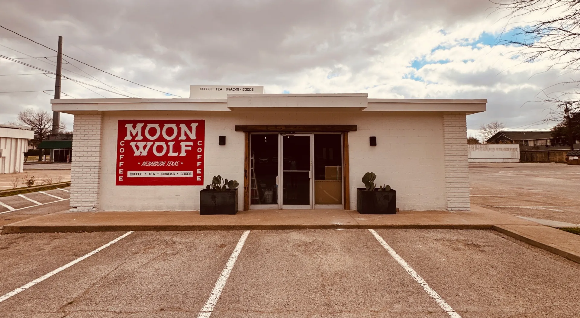 Moon Wolf Provisions storefront — Richardson, TX. Hand-painted MOON WOLF mural across the front.